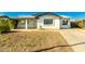 Charming single-story home with a covered porch, white exterior, and a xeriscaped front yard at 214 W June Cir, Mesa, AZ 85201