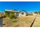 Inviting single-story home boasting a covered porch, xeriscaped yard, and a mature citrus tree at 214 W June Cir, Mesa, AZ 85201