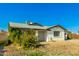 Attractive single-story house featuring a well-maintained exterior, xeriscaped yard, and mature citrus tree at 214 W June Cir, Mesa, AZ 85201