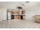 Spacious kitchen featuring wooden cabinets, stainless steel appliances, and tile flooring throughout at 214 W June Cir, Mesa, AZ 85201