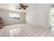 Spacious living room with bright natural light, white walls, and white tile flooring at 214 W June Cir, Mesa, AZ 85201