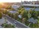 Aerial view of property, lush trees, solar panels in neighborhood, and city skyline in the distance at 220 E 14Th St, Tempe, AZ 85281