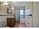 Well-lit bathroom with a tiled shower/tub and wood vanity at 220 E 14Th St, Tempe, AZ 85281