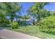 Charming single-story home with lush greenery and a vibrant blue trim, creating a welcoming curb appeal at 220 E 14Th St, Tempe, AZ 85281