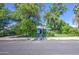 A charming single-story home framed by mature trees, showcasing its inviting curb appeal at 220 E 14Th St, Tempe, AZ 85281