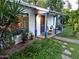 Charming exterior featuring a quaint front porch, lush landscaping, and bright blue accents at 220 E 14Th St, Tempe, AZ 85281