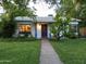 Charming single-story home featuring a well-maintained lawn and inviting blue-accented entryway at 220 E 14Th St, Tempe, AZ 85281