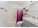 Bright bathroom with tile floor featuring a modern vanity, toilet, and a bathtub with a shower curtain at 2395 S Arizona Rd, Apache Junction, AZ 85119