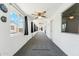 Enclosed carpeted patio with windows and ceiling fans, offering additional living or recreation space at 2395 S Arizona Rd, Apache Junction, AZ 85119
