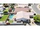 Aerial view of a home with a private swimming pool, well-maintained yard, and tile roof at 3016 N 109Th Ave, Avondale, AZ 85392