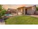An inviting backyard featuring a pool, lawn, a covered patio and additional living structures at 3016 N 109Th Ave, Avondale, AZ 85392