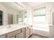 The bright bathroom offers double sinks, a soaking tub, and a glass-enclosed shower at 3016 N 109Th Ave, Avondale, AZ 85392