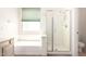 This bathroom has a separate glass shower and tub, with plenty of natural light at 3016 N 109Th Ave, Avondale, AZ 85392