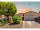 A charming single-story home with desert landscaping, a spacious driveway, and a two-car garage at 3016 N 109Th Ave, Avondale, AZ 85392