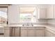 A functional kitchen features a stainless steel dishwasher, sink, and ample cabinet storage at 3016 N 109Th Ave, Avondale, AZ 85392