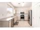 The bright kitchen has stainless steel appliances, light countertops, and tile flooring at 3016 N 109Th Ave, Avondale, AZ 85392