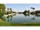 Scenic lake view surrounded by beautiful houses with tranquil water and lush trees at 3016 N 109Th Ave, Avondale, AZ 85392