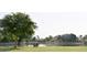 Picturesque lake view with a bench under a tree; relax and enjoy the natural scenery at 3016 N 109Th Ave, Avondale, AZ 85392