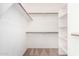 An organized walk-in closet with ample shelving and hanging rods for storage and organization at 3016 N 109Th Ave, Avondale, AZ 85392