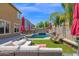 Serene backyard with a sparkling pool, outdoor furniture, and lush landscaping, perfect for enjoying sunny days at 3436 E Gary Way, Gilbert, AZ 85234