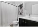 Bathroom with white shower curtain, black vanity, white toilet, and decorative wall art at 3436 E Gary Way, Gilbert, AZ 85234