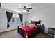 Bedroom featuring a queen bed, black night stand, ceiling fan, and neutral colored carpet at 3436 E Gary Way, Gilbert, AZ 85234