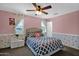 Bedroom featuring a queen bed, white night stand and colorful floral wall decorations at 3436 E Gary Way, Gilbert, AZ 85234