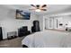 Spacious bedroom featuring a ceiling fan, TV, and dresser, with an open doorway to another room at 3436 E Gary Way, Gilbert, AZ 85234
