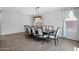 Dining room featuring a large table with seating for ten, modern light fixture, and tile flooring at 3436 E Gary Way, Gilbert, AZ 85234