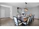 Dining room featuring a large table with seating for ten, modern light fixture, and tile flooring at 3436 E Gary Way, Gilbert, AZ 85234