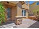 Home exterior with brick-paved patio and small palm trees, showcasing the beautiful front door at 3436 E Gary Way, Gilbert, AZ 85234