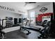 Spacious home gym equipped with weights, treadmill, and mirrored wall with motivational artwork at 3436 E Gary Way, Gilbert, AZ 85234