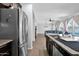 Open-concept kitchen with view into the living area featuring stainless steel refrigerator at 3436 E Gary Way, Gilbert, AZ 85234