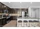 Bright kitchen with a granite island and bar seating, featuring stainless steel appliances at 3436 E Gary Way, Gilbert, AZ 85234
