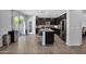 Elegant kitchen boasts dark cabinetry, a granite island with seating, and stainless appliances at 3436 E Gary Way, Gilbert, AZ 85234