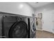 A laundry room featuring a modern washer and dryer set with tile flooring and a motivational wall hanging at 3436 E Gary Way, Gilbert, AZ 85234