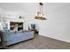 Open-concept living room features modern light fixture, grey sofa and kitchen access at 3436 E Gary Way, Gilbert, AZ 85234