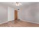 Neutral bedroom featuring a ceiling fan, closet, and wood-look flooring at 3823 W Berridge Ln, Phoenix, AZ 85019