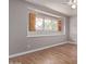 Bedroom featuring wood floors, neutral paint, a ceiling fan, and window with shutters at 3823 W Berridge Ln, Phoenix, AZ 85019