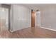 Bedroom featuring wood-look floors, a closet, and neutral paint at 3823 W Berridge Ln, Phoenix, AZ 85019