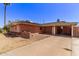 Lovely one-story brick home with a spacious driveway and cozy carport under a clear blue sky at 3823 W Berridge Ln, Phoenix, AZ 85019
