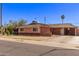 Charming single Gathering home boasts a brick exterior, a shingle roof and a green lawn at 3823 W Berridge Ln, Phoenix, AZ 85019