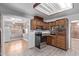 Classic kitchen with wood cabinets, electric range, microwave, and light wood flooring at 3823 W Berridge Ln, Phoenix, AZ 85019