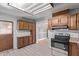Traditional kitchen design with wood cabinetry and an electric range oven at 3823 W Berridge Ln, Phoenix, AZ 85019