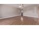 Unfurnished living room with wood look floors, a ceiling fan and a decorative front door at 3823 W Berridge Ln, Phoenix, AZ 85019