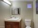 Bathroom features a toilet, vanity with sink and a framed mirror over a tiled countertop at 4008 N 85Th St, Scottsdale, AZ 85251