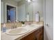 Bathroom featuring double sinks, a tiled countertop and a view of the adjacent shower at 4008 N 85Th St, Scottsdale, AZ 85251