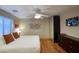 Bright bedroom features a king bed, hard wood floors, and flat screen television mounted on the wall at 4008 N 85Th St, Scottsdale, AZ 85251