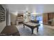Spacious rec room with a pool table, stone fireplace, and open dining area at 4008 N 85Th St, Scottsdale, AZ 85251