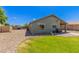 This backyard features low maintenance landscaping, a covered patio, and a built-in grill at 4100 S Dewdrop Ct, Gilbert, AZ 85297